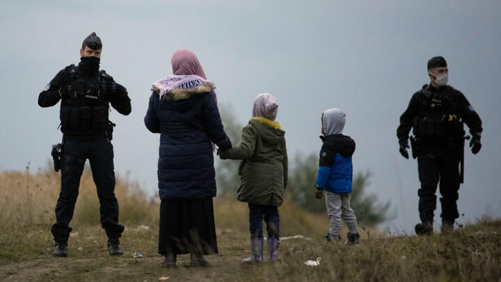 Police officers patrol near a migrant camp in Calais, northern France, on October 14, 2021.